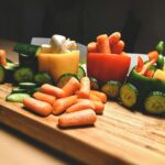 “내 몸에 딱 맞는 영양, 일상 속 똑똑하게 챙기기” sliced carrots and green bell pepper on brown wooden chopping board