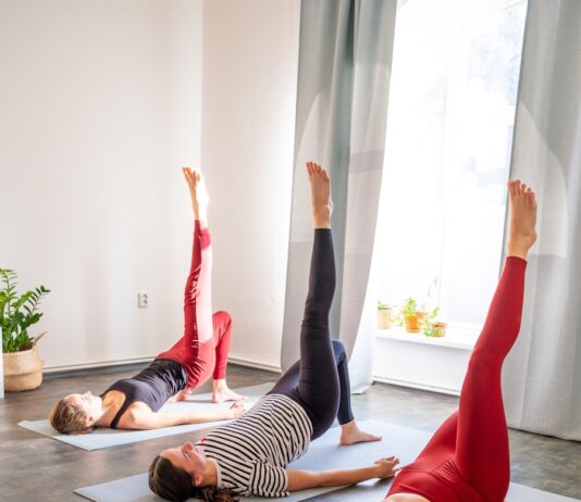 필라테스, 집에서도 손쉽게! 건강 트렌드로 자리매김 Three women doing bridge pose yoga