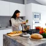 바쁜 일상 속 스트레스, 건강하게 풀기 위한 실천법 주목 woman smiling while cooking